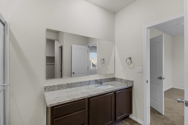 bathroom featuring vanity and baseboards