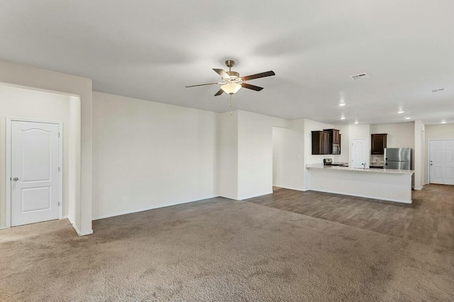 unfurnished living room featuring ceiling fan, visible vents, carpet flooring, and recessed lighting