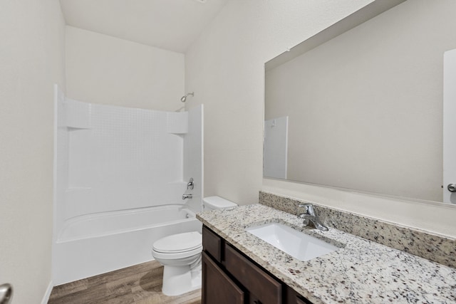 bathroom featuring  shower combination, vanity, toilet, and wood finished floors