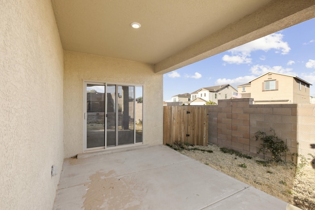 view of patio with a residential view and fence