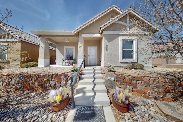 view of front of home with a tiled roof and stucco siding