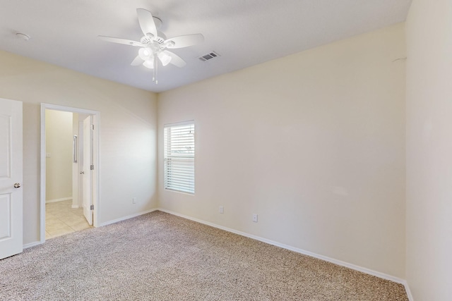 empty room with ceiling fan, baseboards, visible vents, and light colored carpet