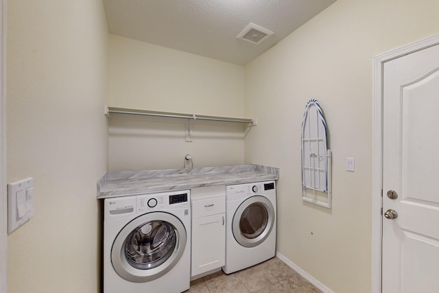 laundry area with washer and clothes dryer, cabinet space, visible vents, light tile patterned flooring, and baseboards