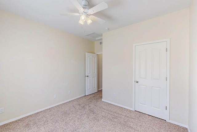 unfurnished bedroom featuring baseboards, visible vents, a ceiling fan, and light colored carpet