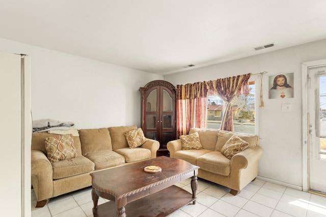 living area featuring visible vents and light tile patterned flooring