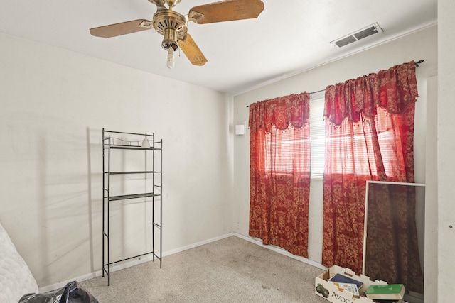 unfurnished room with a ceiling fan, carpet flooring, visible vents, and baseboards