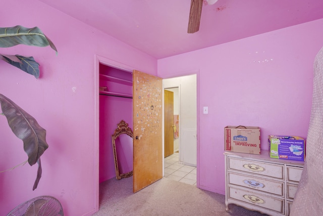 bedroom with ceiling fan, a closet, and carpet