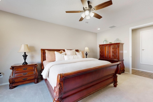 bedroom with ceiling fan, recessed lighting, light colored carpet, visible vents, and baseboards