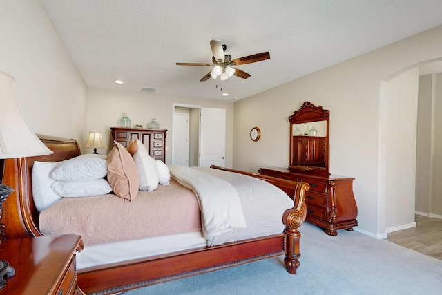 bedroom with arched walkways, recessed lighting, visible vents, and baseboards