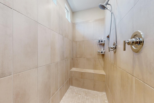 bathroom with a tile shower