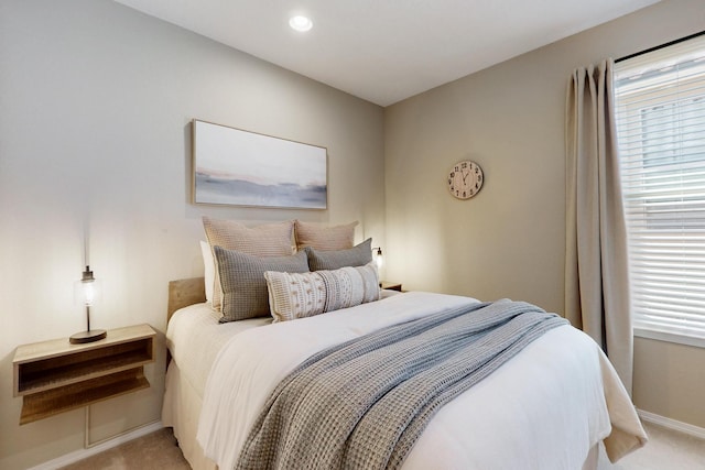 bedroom featuring recessed lighting, light colored carpet, and baseboards