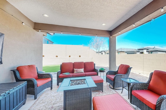 view of patio featuring an outdoor living space with a fire pit and a fenced backyard