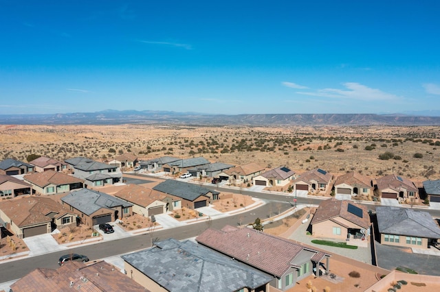 aerial view with a residential view, a mountain view, and view of desert