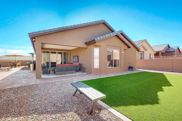 back of house with a patio area, outdoor lounge area, fence, and stucco siding