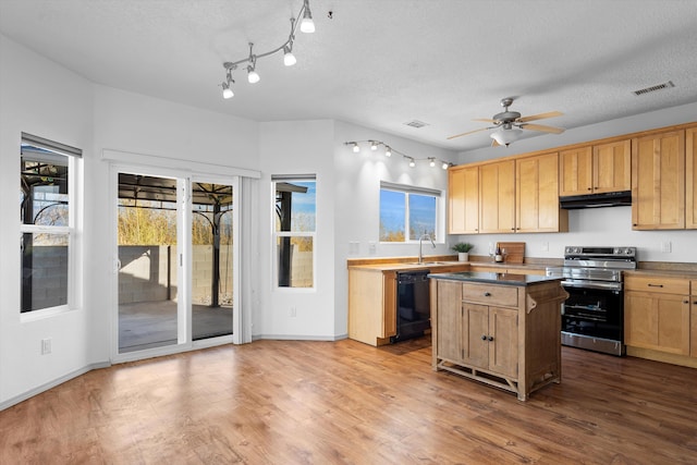 kitchen with visible vents, electric stove, dishwasher, under cabinet range hood, and a sink