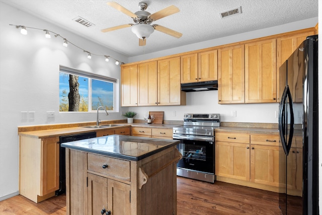 kitchen featuring stainless steel electric range oven, freestanding refrigerator, a sink, under cabinet range hood, and dishwashing machine