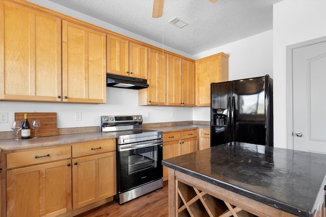 kitchen with black fridge with ice dispenser, wood finished floors, a textured ceiling, stainless steel range with electric cooktop, and under cabinet range hood