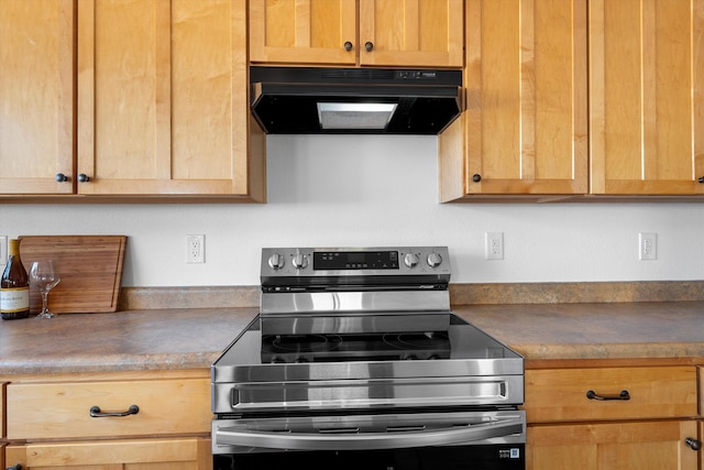 kitchen featuring stainless steel range with electric stovetop, dark countertops, light brown cabinetry, and exhaust hood