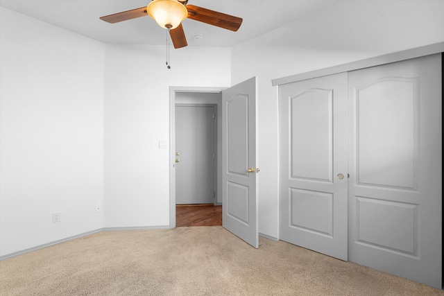 unfurnished bedroom featuring a closet, carpet, and a ceiling fan