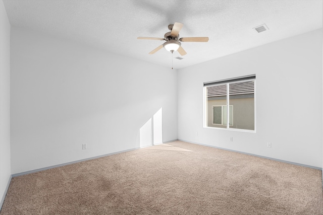 unfurnished room featuring baseboards, visible vents, a ceiling fan, a textured ceiling, and carpet floors