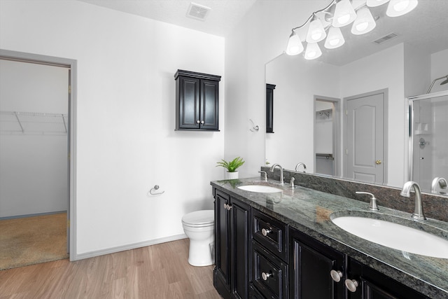 full bath featuring a sink, visible vents, and a shower stall