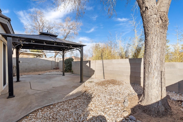 view of patio featuring a fenced backyard and a gazebo