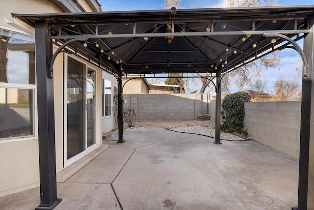 view of patio with a fenced backyard and a gazebo