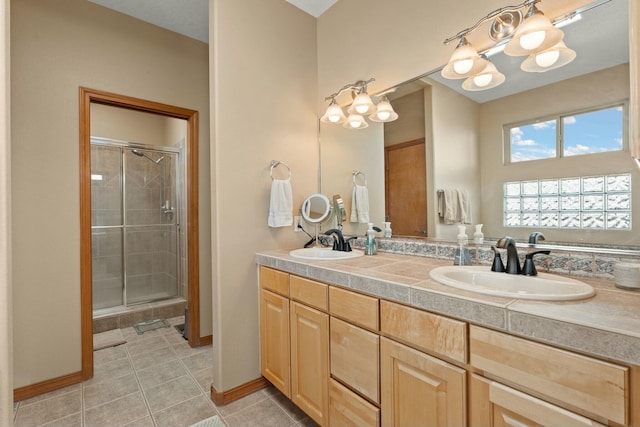 full bathroom with tile patterned flooring, a shower stall, and a sink