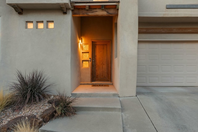 doorway to property featuring stucco siding