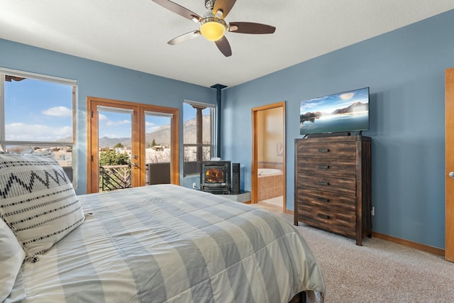 bedroom with connected bathroom, carpet flooring, baseboards, access to outside, and french doors