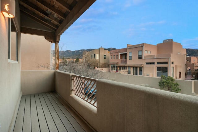 balcony featuring a residential view and a mountain view