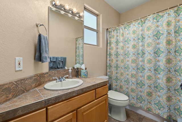 bathroom featuring toilet, curtained shower, tile patterned flooring, and vanity