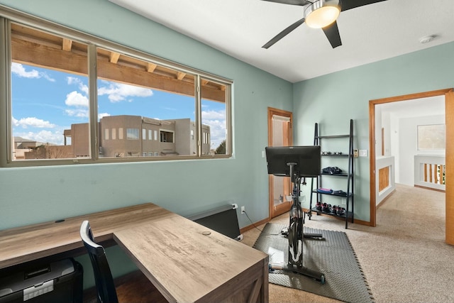 office space with light colored carpet, ceiling fan, and baseboards