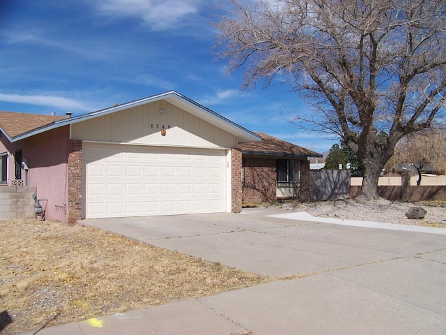 single story home with an attached garage, brick siding, fence, driveway, and roof with shingles