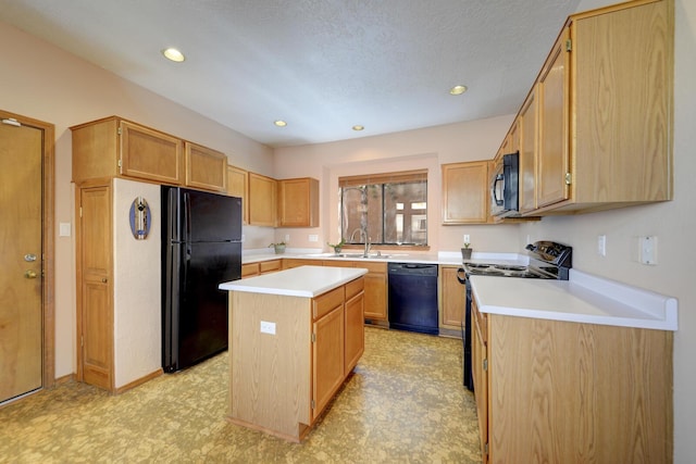 kitchen with light floors, a sink, light countertops, a center island, and black appliances