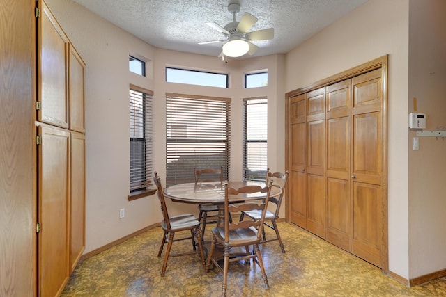 dining area with ceiling fan, a textured ceiling, and baseboards