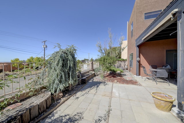 view of patio featuring fence