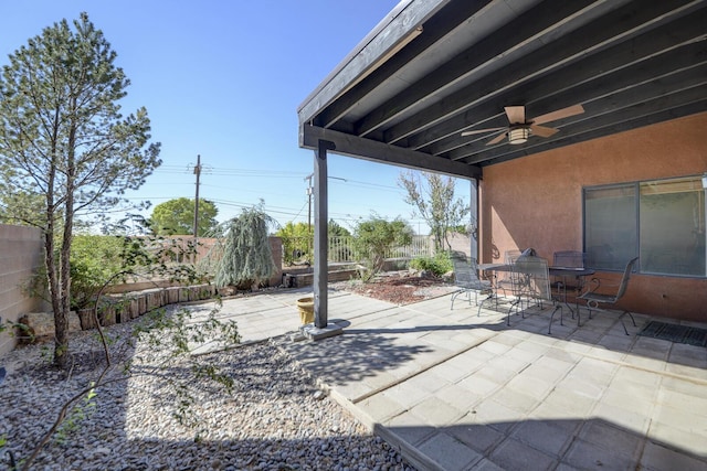 view of patio / terrace featuring ceiling fan, outdoor dining space, and a fenced backyard