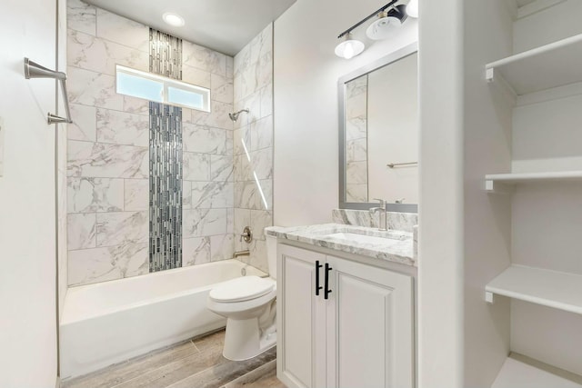 bathroom featuring shower / washtub combination, wood tiled floor, vanity, and toilet