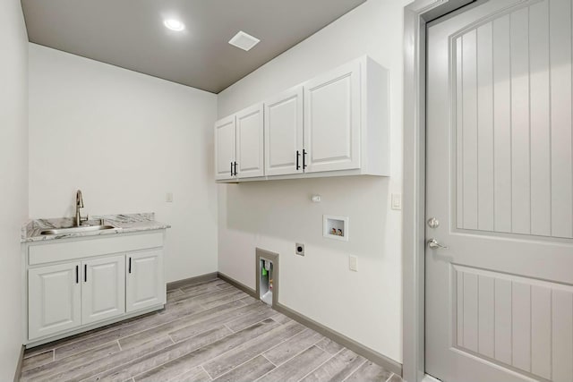 laundry room featuring hookup for a washing machine, hookup for a gas dryer, cabinet space, a sink, and electric dryer hookup