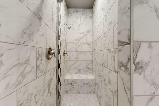 bathroom with a tile shower