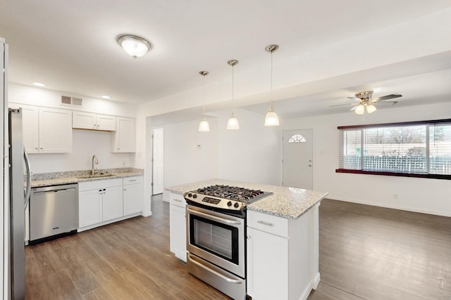 kitchen featuring a sink, visible vents, white cabinetry, light wood-style floors, and appliances with stainless steel finishes