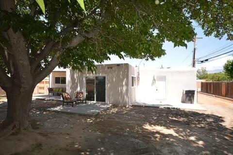 rear view of property featuring a patio and fence