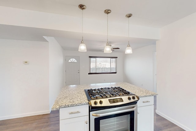 kitchen featuring stainless steel range with gas cooktop, light stone counters, and pendant lighting