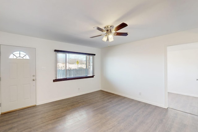 entryway featuring dark wood finished floors, baseboards, and ceiling fan