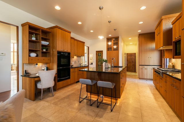 kitchen with open shelves, dobule oven black, stainless steel gas stovetop, a sink, and a kitchen breakfast bar