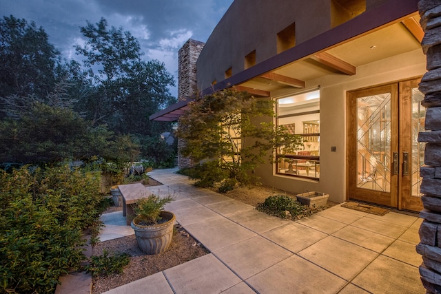 927 Camino Vista Rio, Bernalillo, NM 87004 - view of exterior entry with stucco siding, a chimney, and a patio