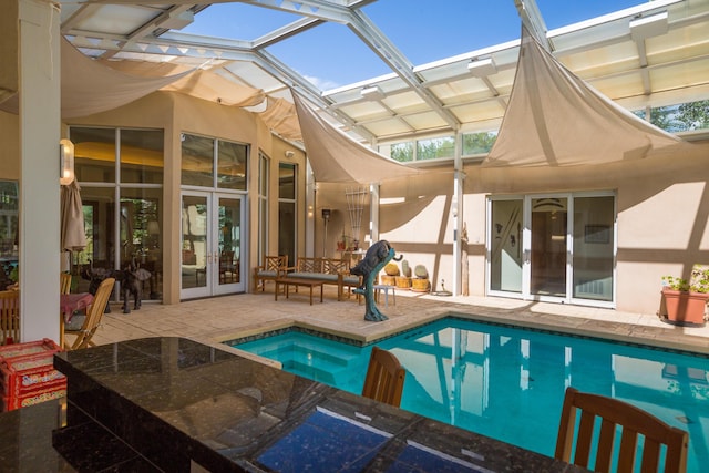 outdoor pool with a patio, french doors, a lanai, and a hot tub