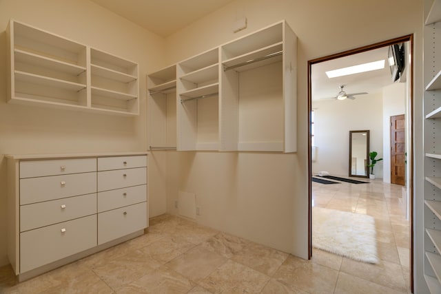 walk in closet with ceiling fan