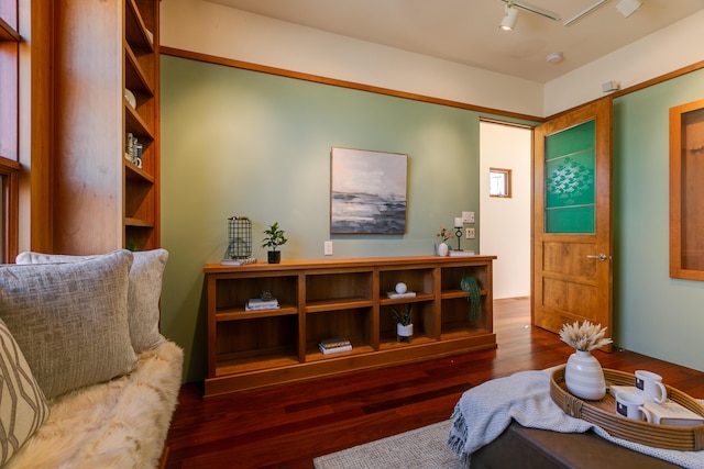 sitting room featuring rail lighting and wood finished floors